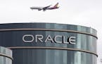 FILE - In this Tuesday, March 20, 2012, file photo, a plane flies over Oracle headquarters in Redwood City, Calif. On Wednesday, June 21, 2017, Oracle