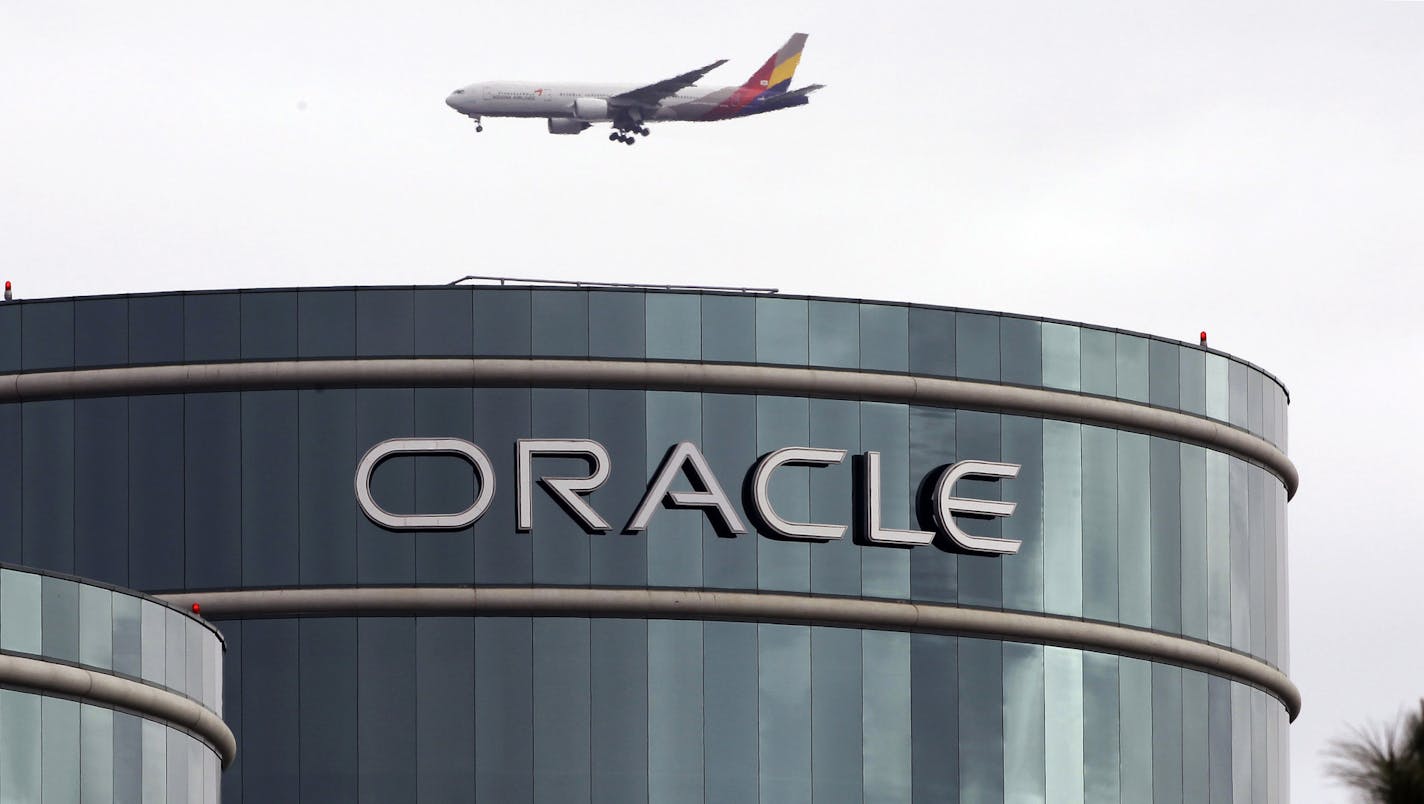 FILE - In this Tuesday, March 20, 2012, file photo, a plane flies over Oracle headquarters in Redwood City, Calif. On Wednesday, June 21, 2017, Oracle Corp. reports financial results. (AP Photo/Paul Sakuma, File) ORG XMIT: NYBZ301