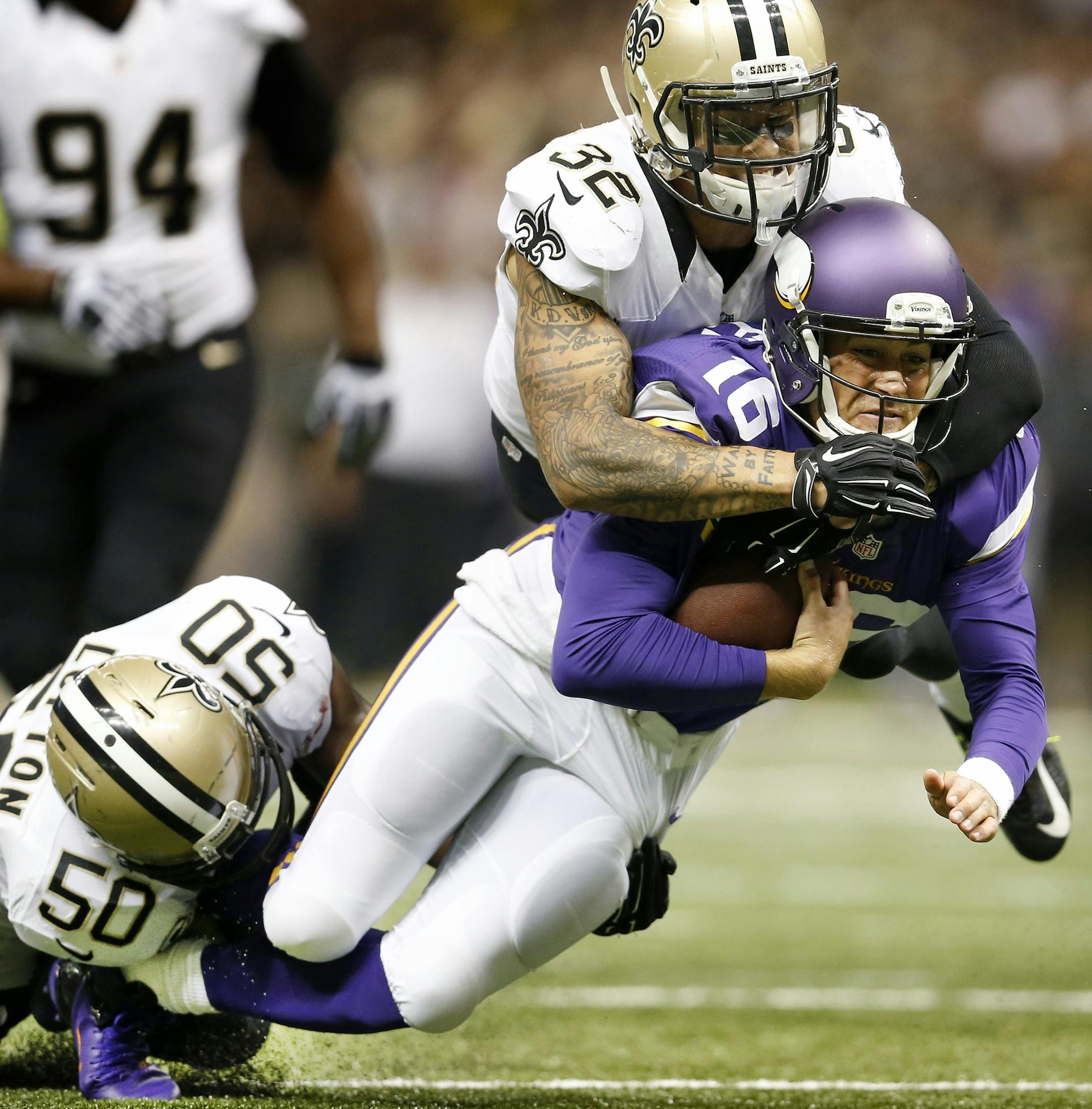 Minnesota Vikings quarterback Matt Cassel (16) was tackled by Curtis Lofton (50) and Kenny Vaccaro (32) during a run in the second quarter. Cassel left the game with an injury after the play. ] CARLOS GONZALEZ cgonzalez@startribune.com - September 21 , 2014 , New Orleans, LA, Mercedes Benz Superdome, NFL, Minnesota Vikings vs. New Orleans Saints