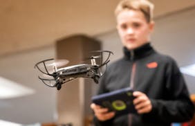 Andrew Dickhausen piloted a small drone around his classroom. Nancy Meyers sixth graders tested robots and drones in order to understand how they work