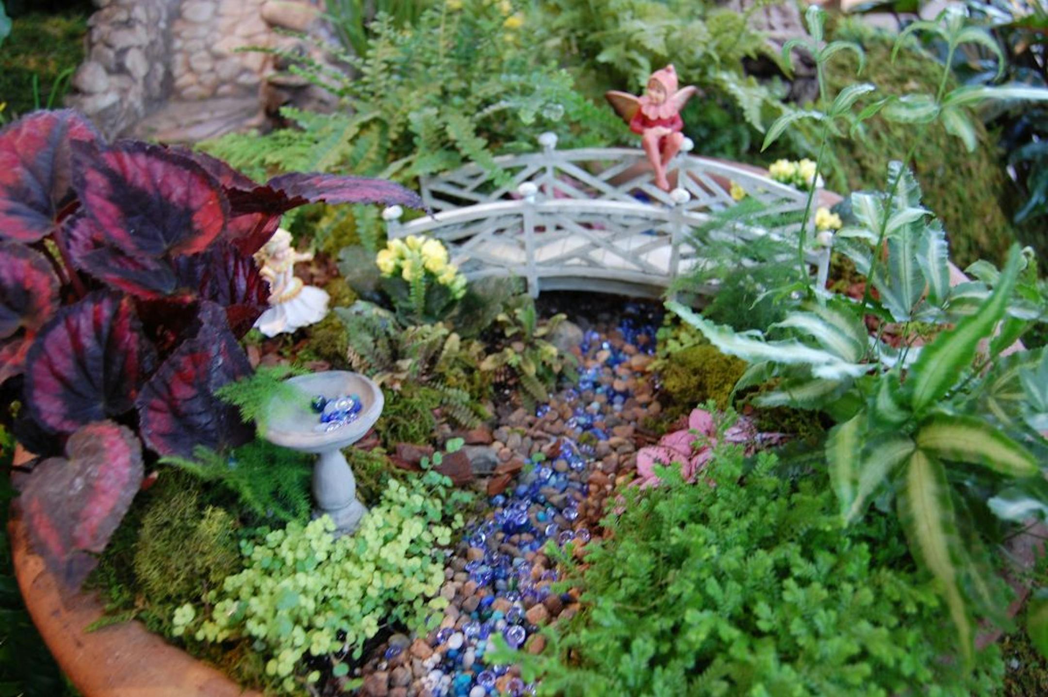 "Tiny Treasures: Fairies & Gnomes" at the Minnesota Landscape Arboretum is a collection of fantasy vignettes of teeny gardens, water features, bridges and fairy figurines hiding under foliage.