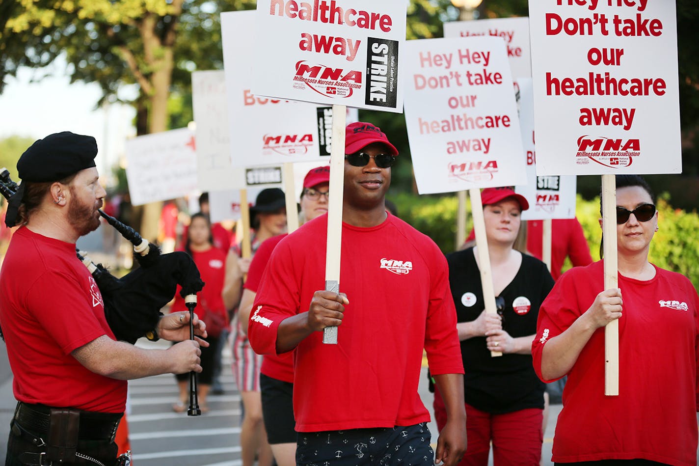 Michael Redmond, a nurse from Abbott Northwestern, played the bagpipes as nurses walked around the hospital on the first day of the strike Sunday June 19, 2016 in Minneapolis, MN.