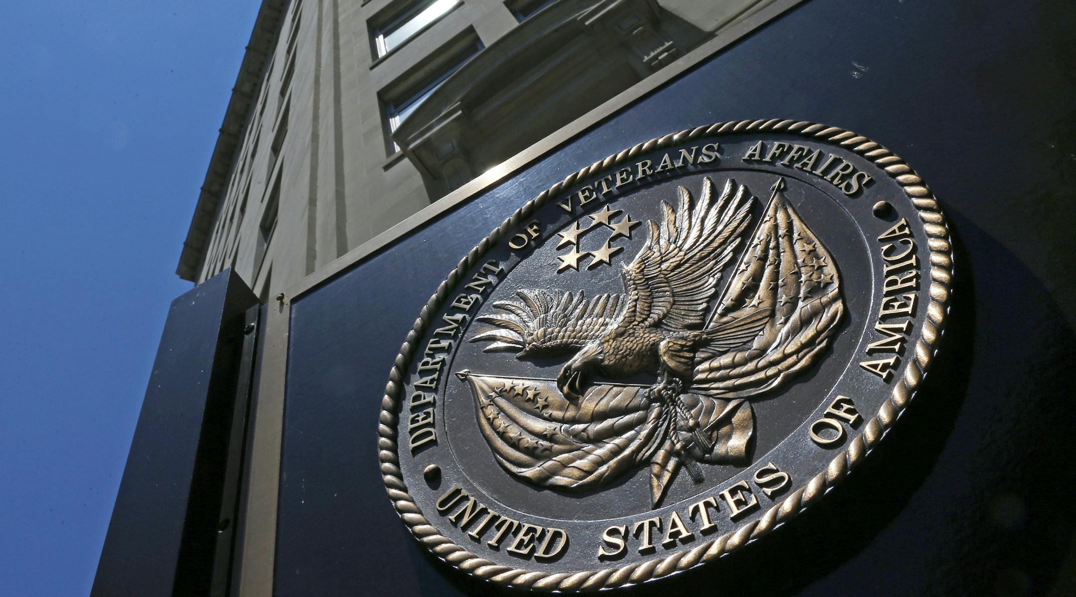 FILE - In this June 21, 2013, file photo, the seal affixed to the front of the Department of Veterans Affairs building in Washington. A new first-of-its kind government study finds suicide among military veterans is especially high in the western U.S. and rural areas. The numbers suggest that social isolation, gun ownership and limited health care access may be factors behind the higher numbers. The Department of Veterans Affairs released data Sept. 15, on suicide by state. (AP Photo/Charles Dha