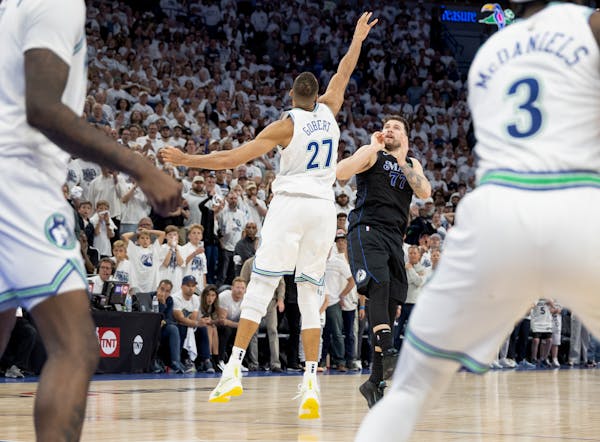 Luka Doncic (77) of the Dallas Mavericks watches his game-winning three-pointer over the Timberwolves' Rudy Gobert with three seconds left in the game