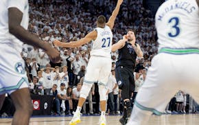 Luka Doncic (77) of the Dallas Mavericks watches his game-winning three-pointer over the Timberwolves' Rudy Gobert with three seconds left in the game