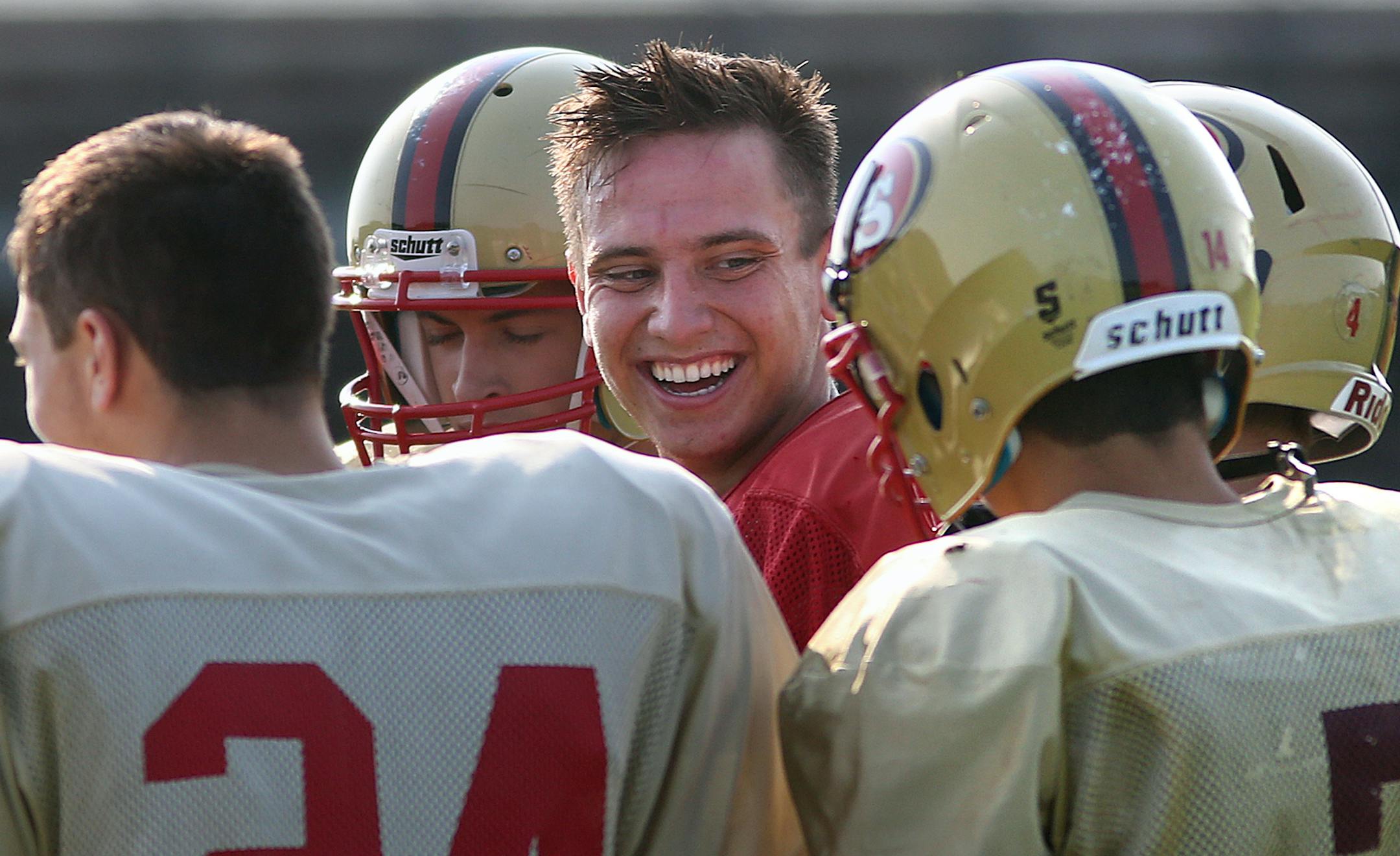Quarterback Will Heller (facing camera) removed his helmet to cool off during a recent practice at Lakeville High School. ] JIM GEHRZ ï james.gehrz@startribune.com / Lakeville, MN / August 26, 2015 / 9:00 AM ñ BACKGROUND INFORMATION: Lakeville South football -- Trying to emerge from Lakeville North's big shadow.