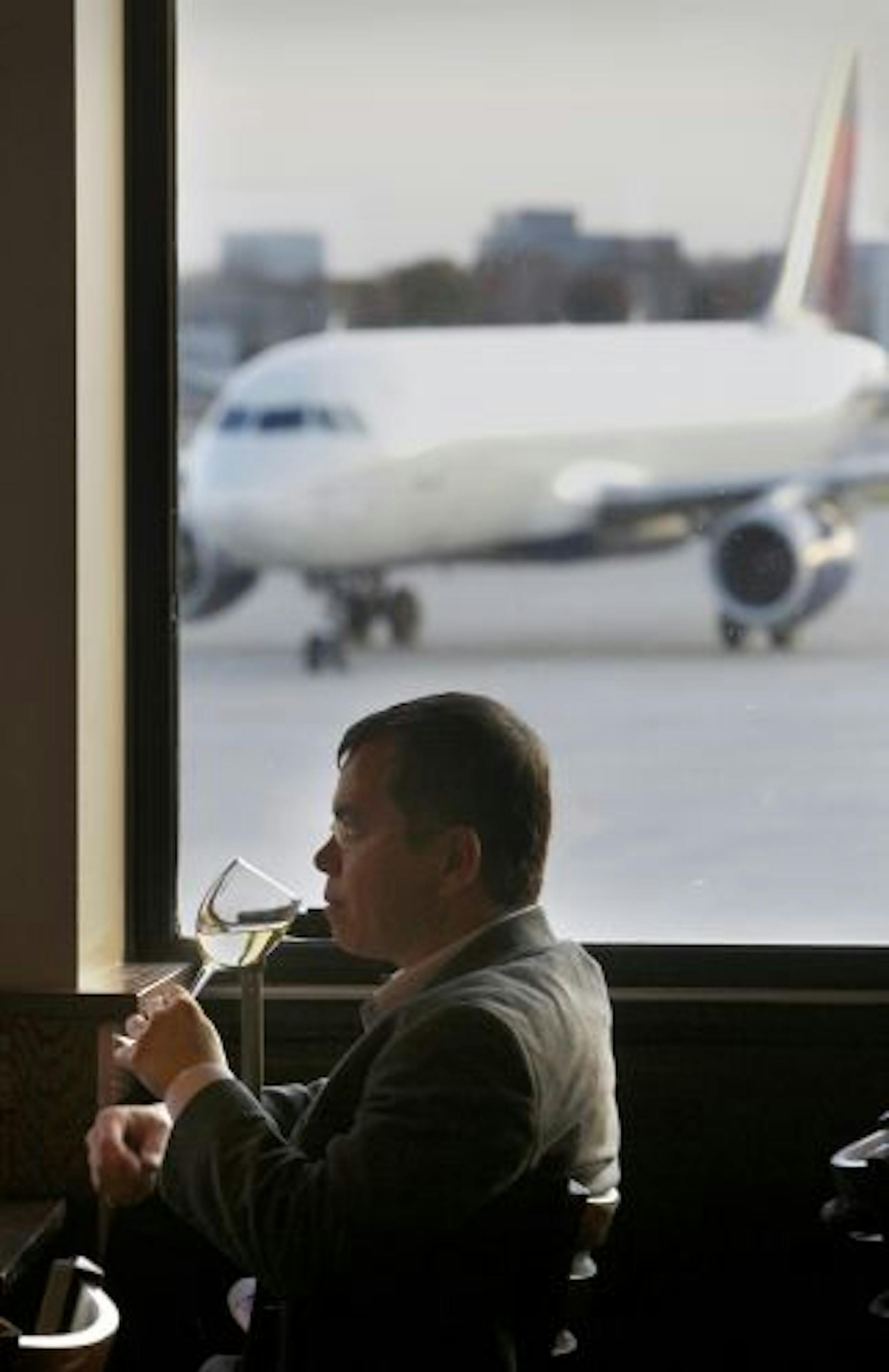 The Airport Bar/restaurants go for a better product and service for the traveler. Carlos Desuchi on a layover from Holland to Atlanta sips a white wine at the O'Gara's Bar and Grill at the MSP airport.