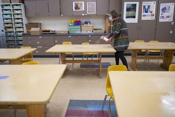 Duluth schools are among those switching to distance learning. In this photo from September, Sophie Gray Spehar disinfected each table in her art clas