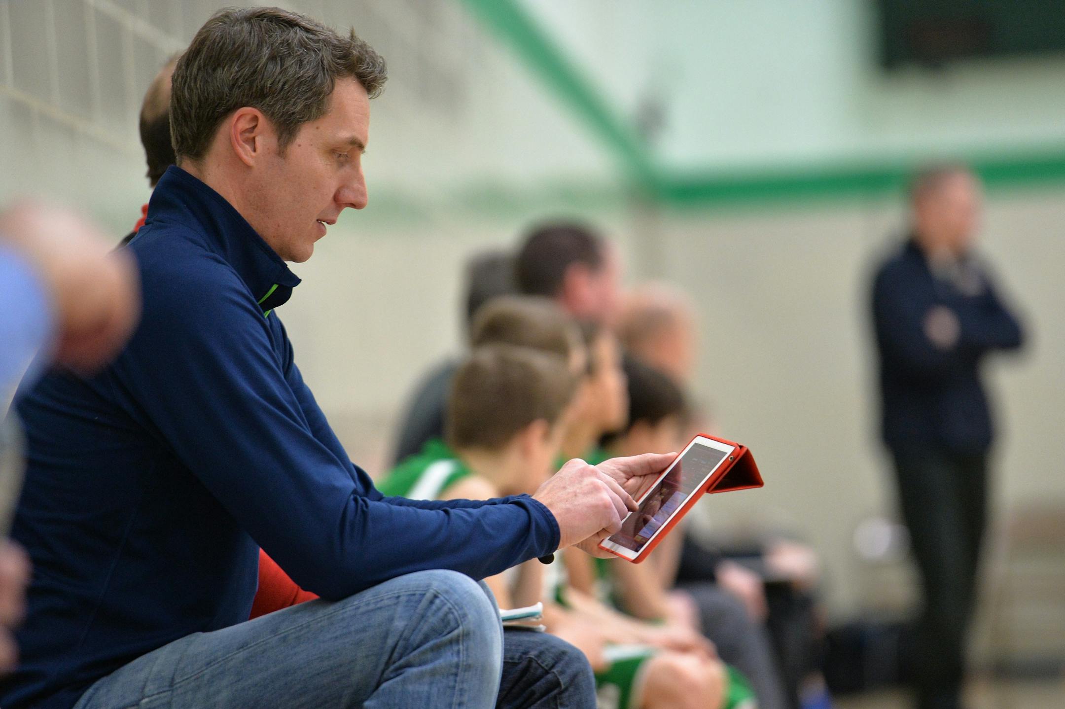 Edina 4A boys' traveling basketball team parent, Mike Munson, records game statistics into the iPad app, iScore.