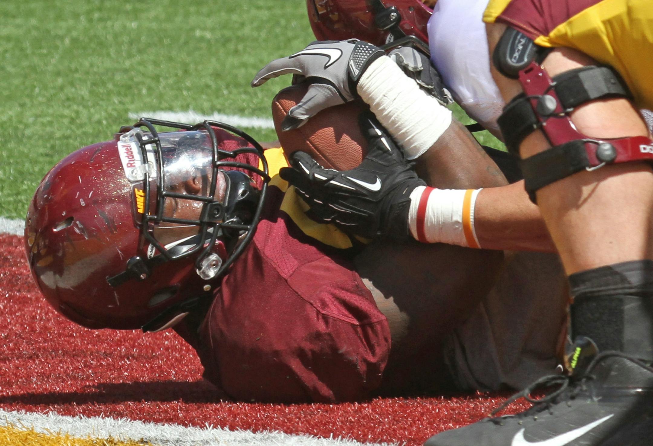 (left to right) Gophers Maroon team running back Donnell Kirkwood punched through for a first half touchdown during the spring game at TCF Stadium on 4/27/13.