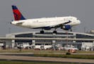 FILE - In this June 24, 2019, file photo a Delta Air Lines aircraft makes its approach at Dallas-Fort Worth International Airport in Grapevine, Texas.