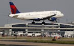 FILE - In this June 24, 2019, file photo a Delta Air Lines aircraft makes its approach at Dallas-Fort Worth International Airport in Grapevine, Texas.