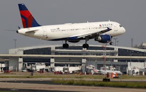 FILE - In this June 24, 2019, file photo a Delta Air Lines aircraft makes its approach at Dallas-Fort Worth International Airport in Grapevine, Texas.