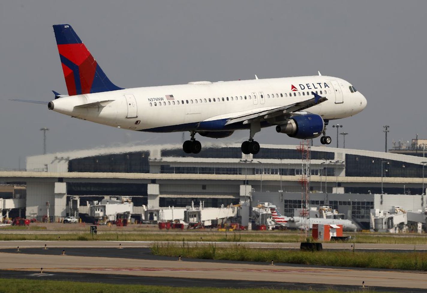 FILE - In this June 24, 2019, file photo a Delta Air Lines aircraft makes its approach at Dallas-Fort Worth International Airport in Grapevine, Texas. Delta Air Lines reports earns Tuesday, Oct. 8.