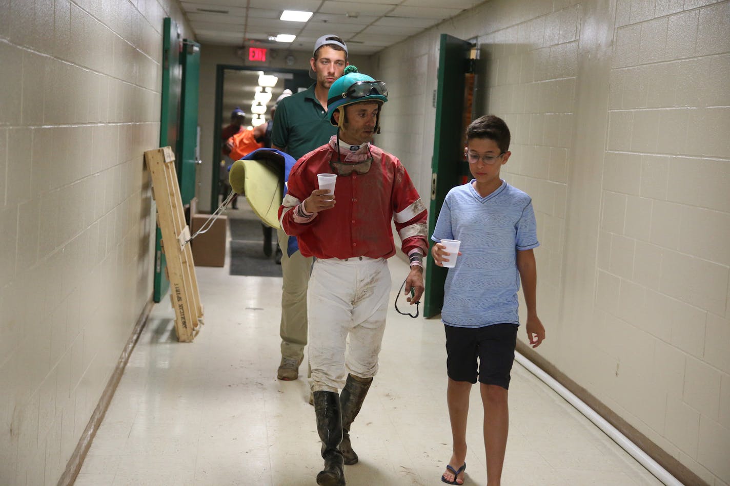 Jockey Leandro Goncalves with his son Guilherme, 13, walked and talked after his fourth race of the evening.