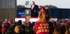 Attendees listen to President Donald Trump on stage during a campaign rally in Murphysboro, Ill., on Saturday, Oct. 27, 2018. Trump has proposed a dif