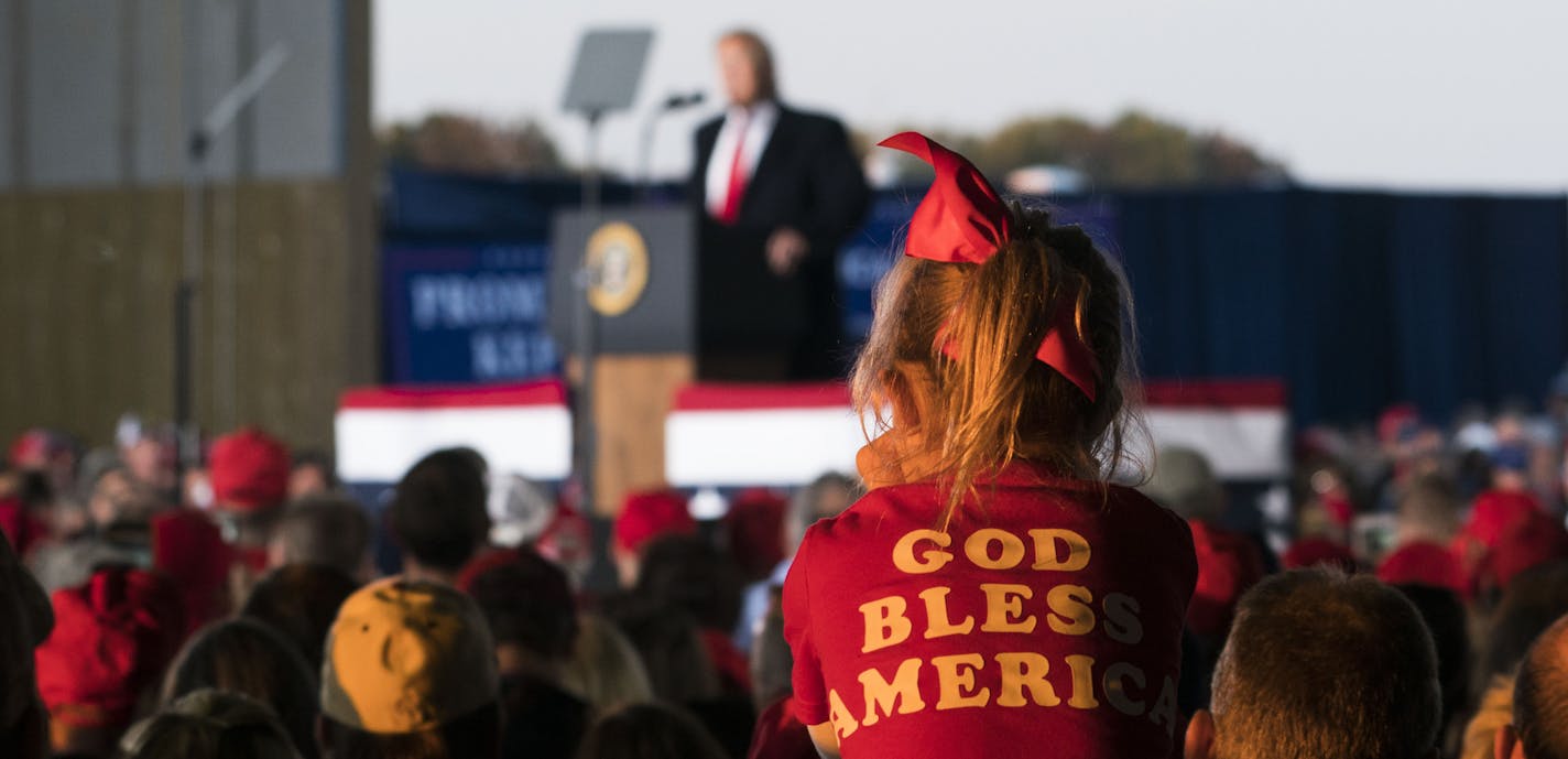 Attendees listen to President Donald Trump on stage during a campaign rally in Murphysboro, Ill., on Saturday, Oct. 27, 2018. Trump has proposed a different reading of the 14th Amendment, one he said denies birthright citizenship to the children of undocumented immigrants. Trump said he was preparing to issue an executive order to that end. (Doug Mills/The New York Times)