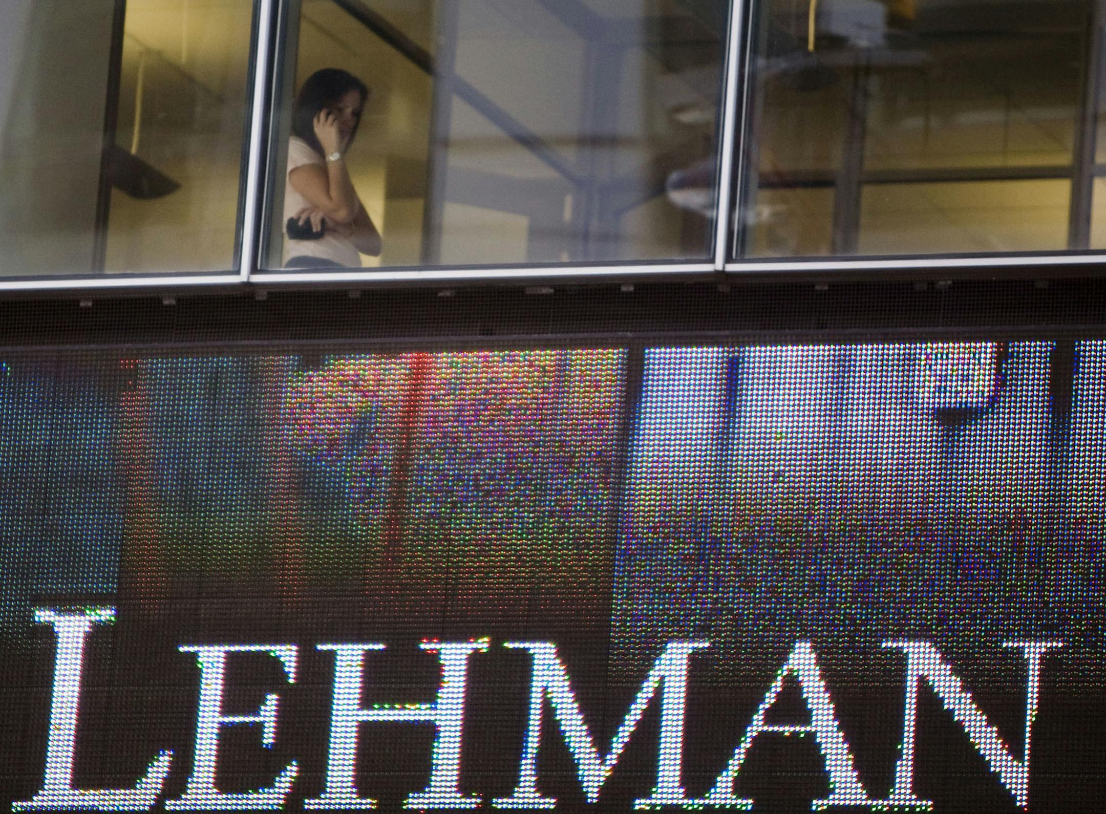 A woman speaks on a cell phone inside the headquarters of Lehman Brothers Holdings Inc., in New York, on Sept. 15, 2008. On that day, Lehman Brothers, the fourth-largest U.S. investment bank, succumbed to the subprime mortgage crisis it helped create in the biggest bankruptcy filing in history. Illustrates LEHMAN (category f) by Yalman Onaran, Michael J. Moore and Max Abelson (c) 2013, Bloomberg News. Moved: Wednesday, Sept. 11, 2013 (MUST CREDIT: Bloomberg News photo by Jeremy Bales).