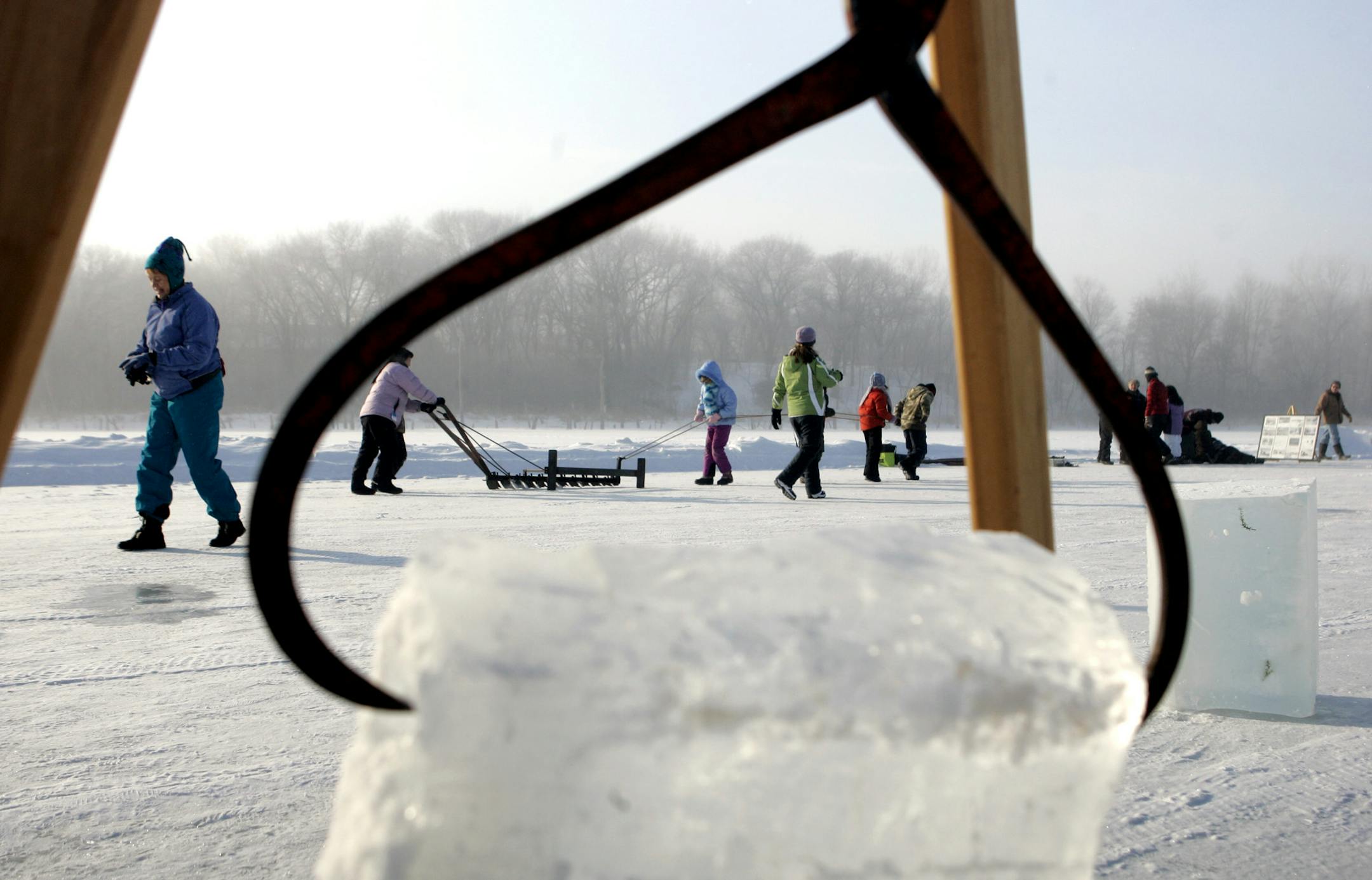 Students from Kenwood Elementary School in Minneapolis cut large blocks of ice with a handsaw during an ice harvest history day at Hyland Park Reserve in Bloomington last week.