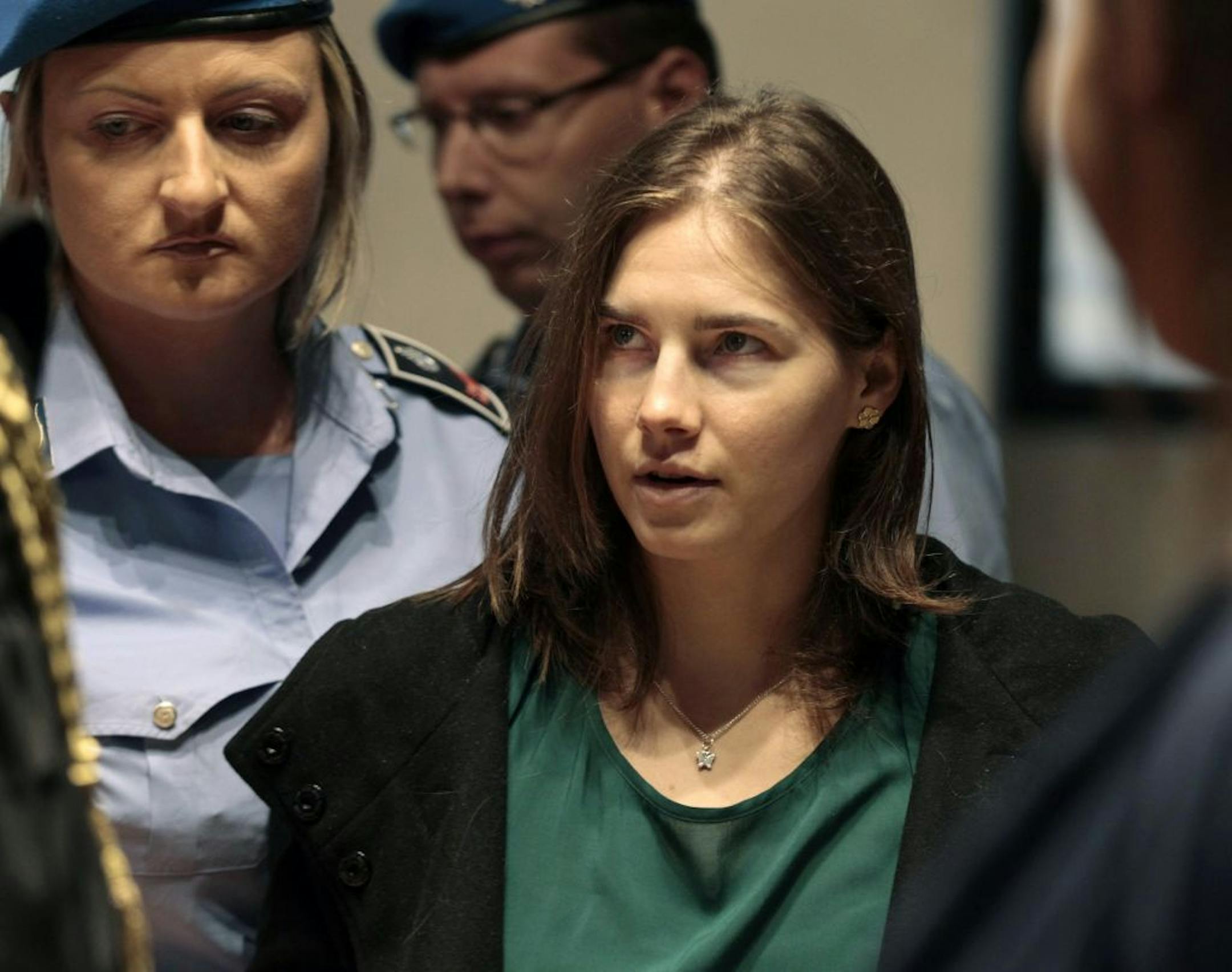 Amanda Knox is escorted as she arrives for an appeal hearing at the Perugia court, central Italy, Monday, Oct. 3, 2011. The 24-year-old Knox looked tense as she entered a packed courthouse. She is expected to address the court in a final plea of her innocence. A verdict is expected later Monday.
