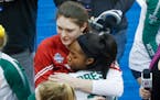 Wisconsin's Dana Rettke, left, embraces Baylor's Yossiana Pressley after a semifinal game of the NCAA Div I Women's Volleyball Championships, Thursday