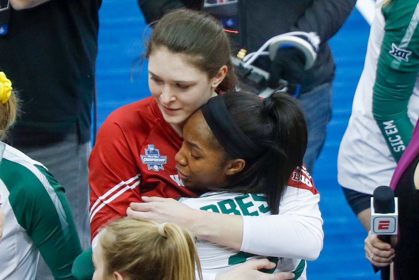 Wisconsin's Dana Rettke, left, embraces Baylor's Yossiana Pressley after a semifinal game of the NCAA Div I Women's Volleyball Championships, Thursday, Dec. 19, 2019, in Pittsburgh. (AP Photo/Keith Srakocic)