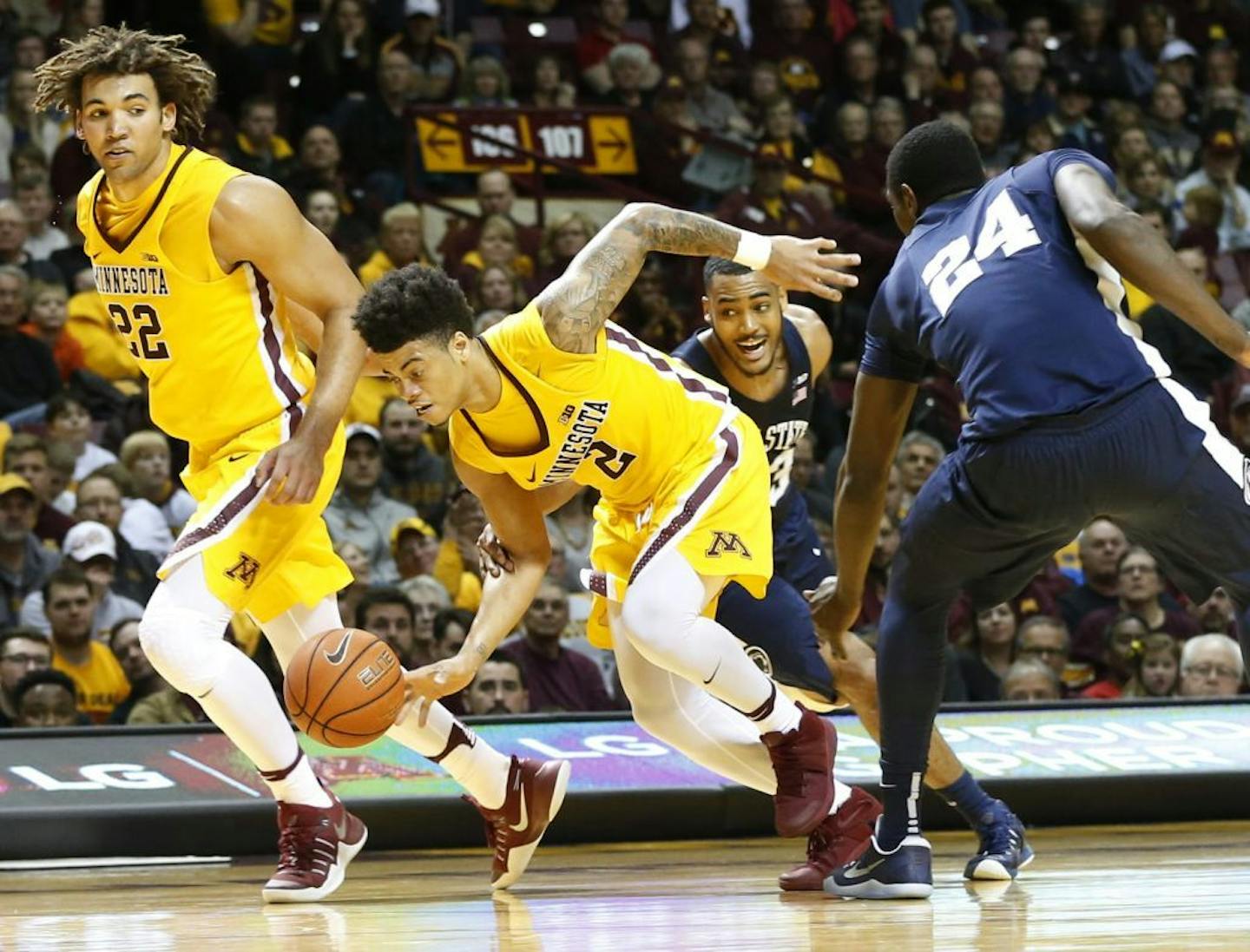 Minnesota's Nate Mason (2) breaks away from Penn State's Mike Watkins, right, and Shep Garner as Minnesota's Reggie Lynch, left, watches during the second half of an NCAA college basketball game Saturday, Feb. 25, 2017, in Minneapolis.