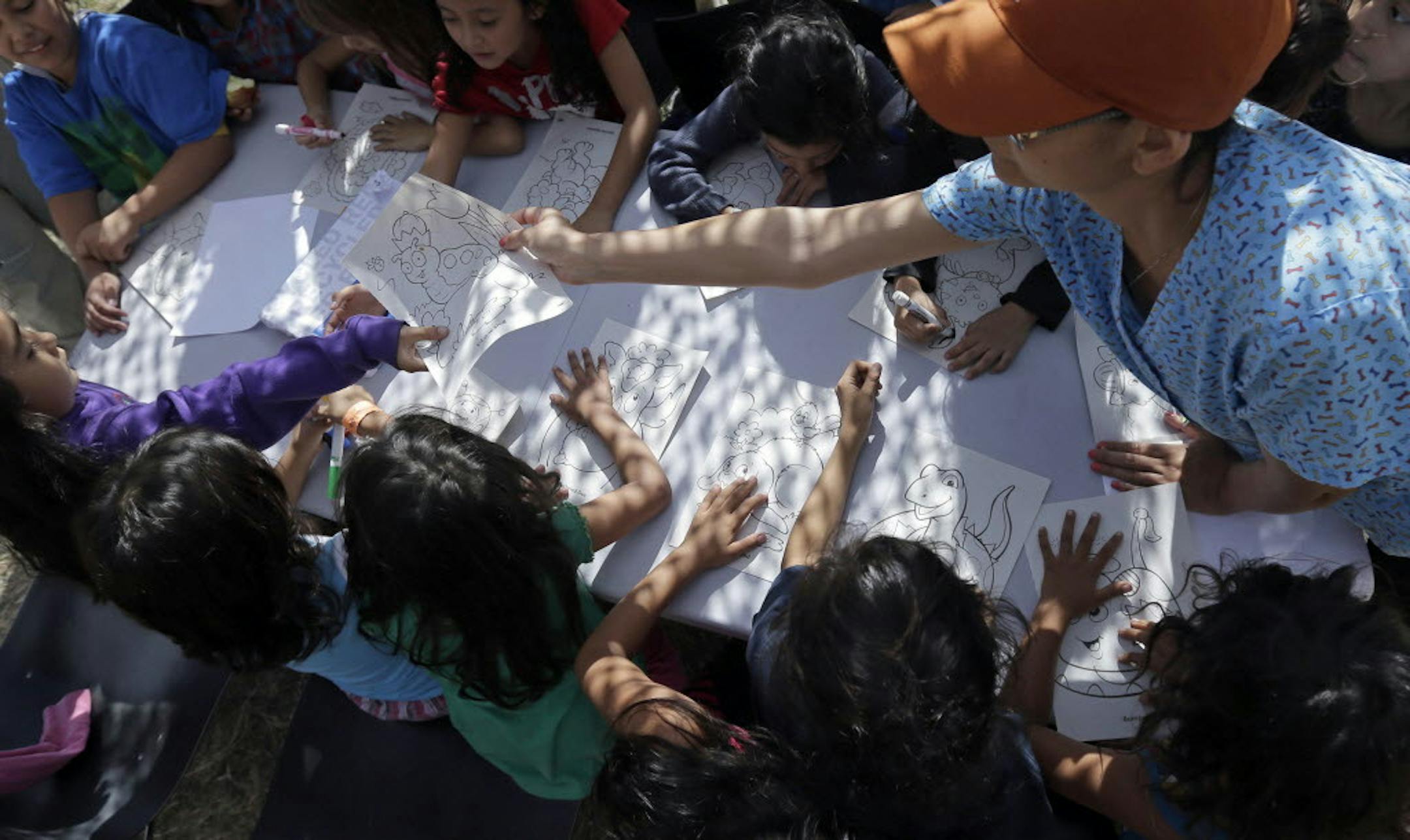 This June 18, 2014 file photo shows children detainees coloring and drawing at a U.S. Customs and Border Protection (CPB) processing facility in Brownsville,Texas.
