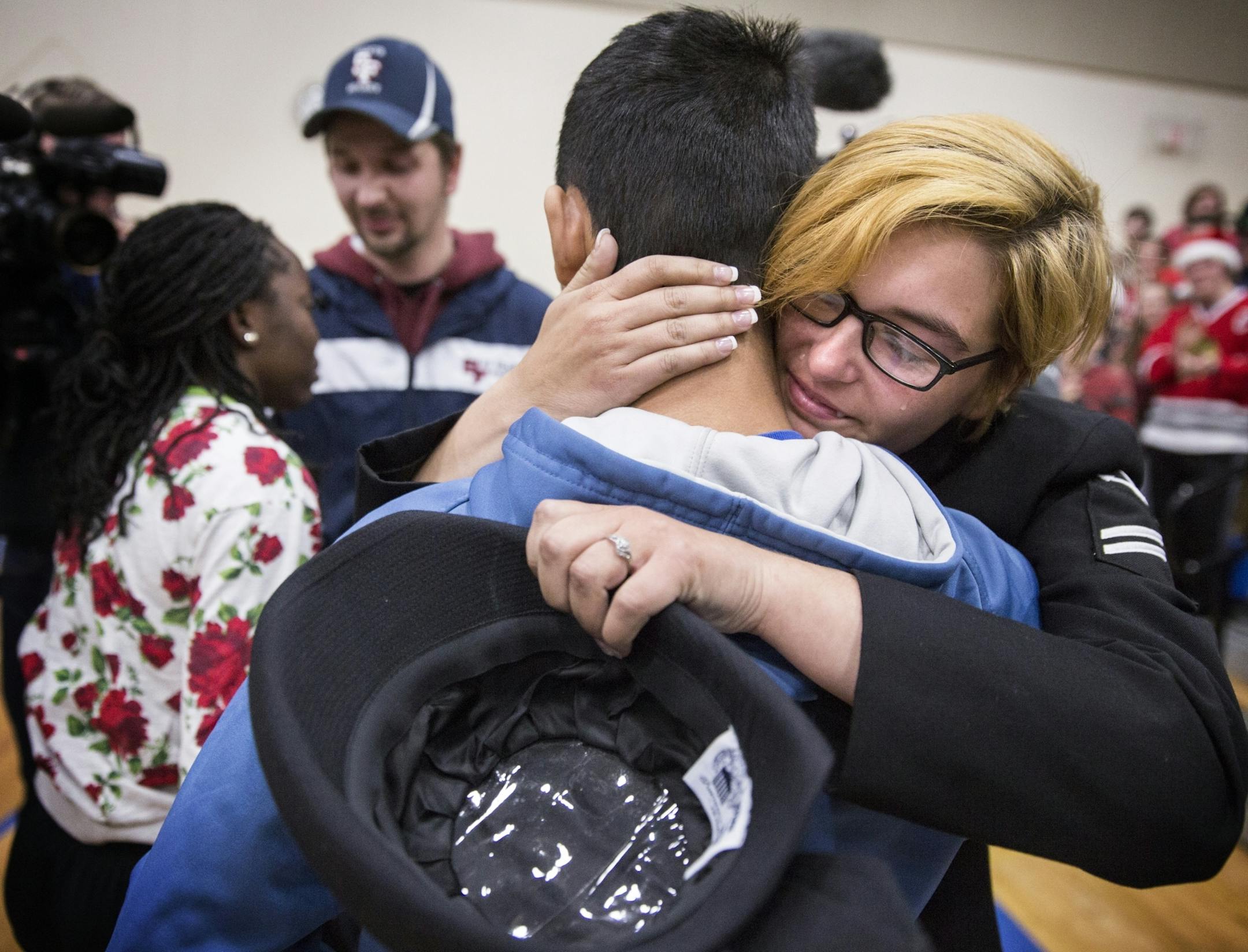 Emma Zabinski, a seaman apprentice in the U.S. Navy stationed in Norfolk, Va., greets her brother Thomas Zabinski, 15, at Academy of Holy Angels in Richfield on Friday, December 18, 2015.