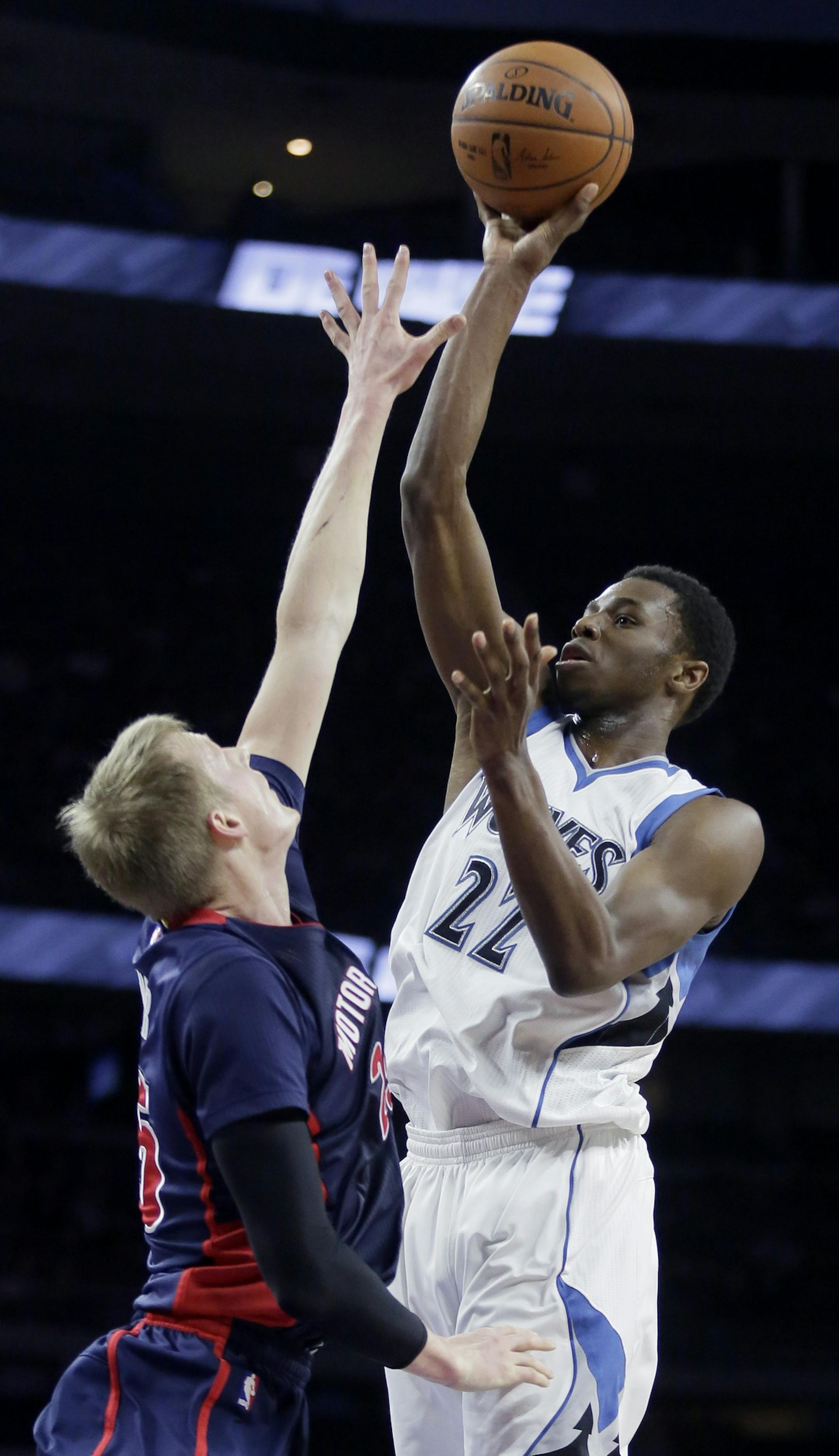 Minnesota Timberwolves' Andrew Wiggins (22) shoots against Detroit Pistons' Kyle Singler during the first half of an NBA basketball game Sunday, Feb. 8, 2015, in Auburn Hills, Mich. (AP Photo/Duane Burleson)