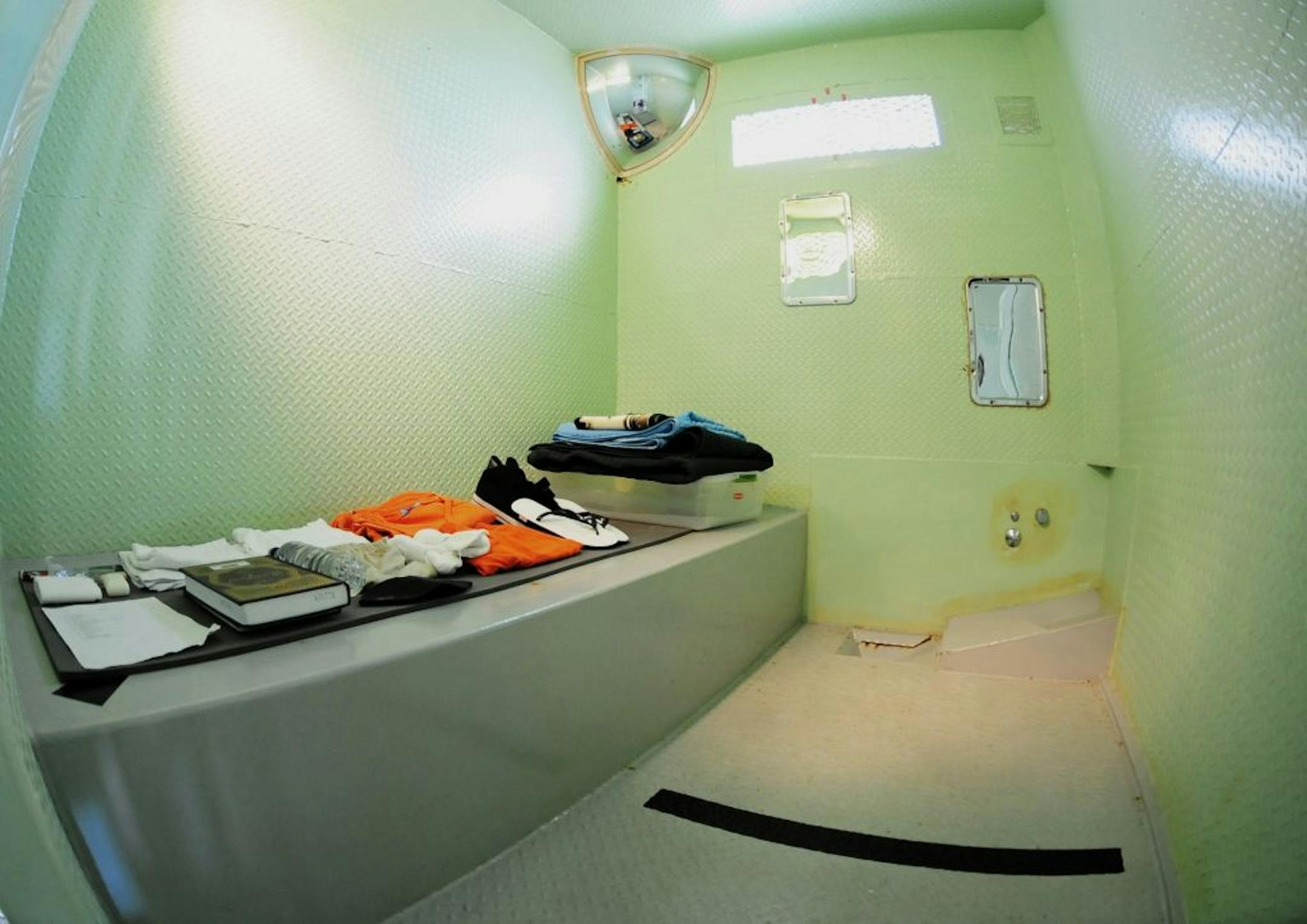 In this image released by the U.S. Military Joint Task Force Guantanamo, the interior of a cell from a disciplinary block known as Five Echo is pictured using an extreme wide-angle lens, at the detention complex at the U.S. Naval Station, Guantanamo Bay, Cuba, Thursday Dec. 8, 2011. Some lawyers for detainees say the cells at Five Echo are inadequate and inhumane. U.S. military officials are defending conditions in Five Echo and say is by its nature harsher than the communal section of Guantanam