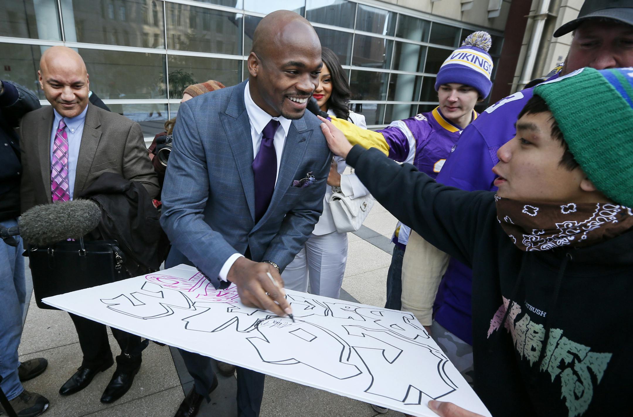 Adrian Peterson signs a poster for Brady Vixayvong of Eagen as he and his his wife Ashley left the Federal Court House in Minneapolis Friday afternoon. ] Adrian Peterson and his wife, Ashley, were present in the packed courtroom at U.S. District Court in downtown Minneapolis for the hearing, which lasted just over an hour. The hearing marked the first time attorneys for the NFL and the NFL Players Association (NFLPA), which is suing on behalf of Peterson, made their case in person to U.S. Distri