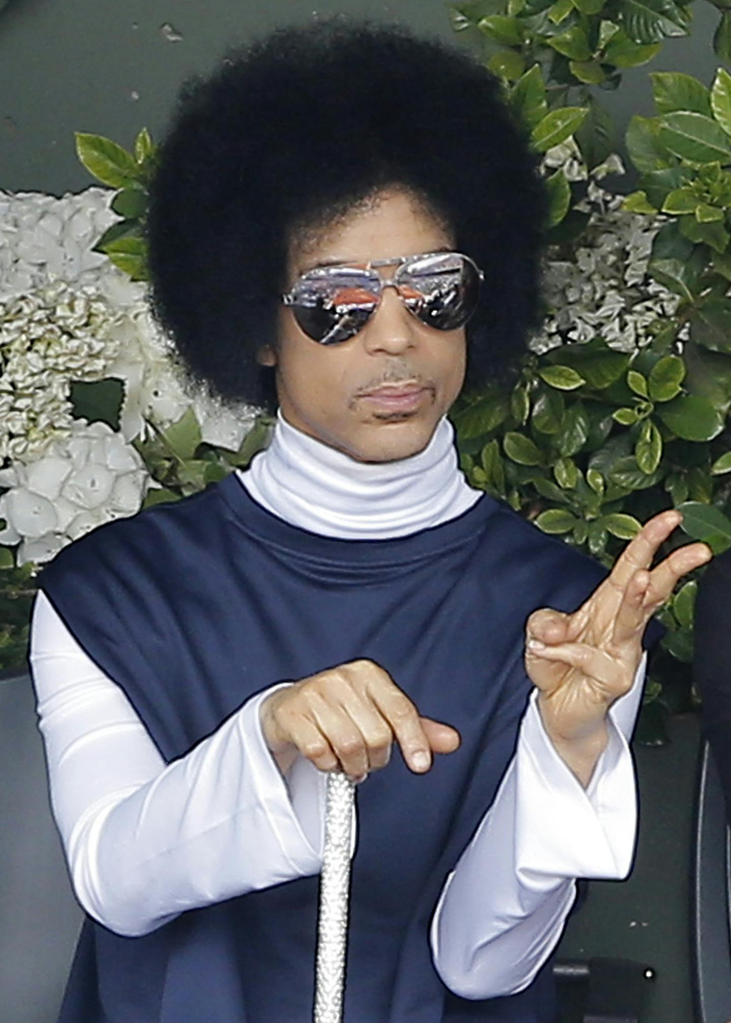 FILE - In this Monday, June 2, 2014, file photo, U.S. pop singer Prince watches the fourth round match of the French Open tennis tournament between Spain's Rafael Nadal and Serbia's Dusan Lajovic at the Roland Garros stadium, in Paris. Prince announced on Monday, Aug. 25, 2014, that he would release a new album entitled, &#xec;Art Official Age&#xee; on Warner Bros. Records, the label Prince was signed to from 1978 to the mid-1990s, but later battled for the rights of his music. (AP Photo/Michel