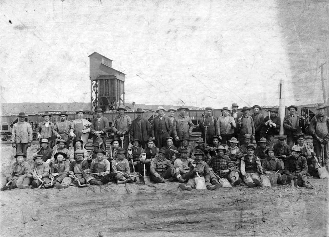 Finnish and Slovenian miners posed for a photo on the Mesabi Iron Range in the early 1900s, possibly 1907.
