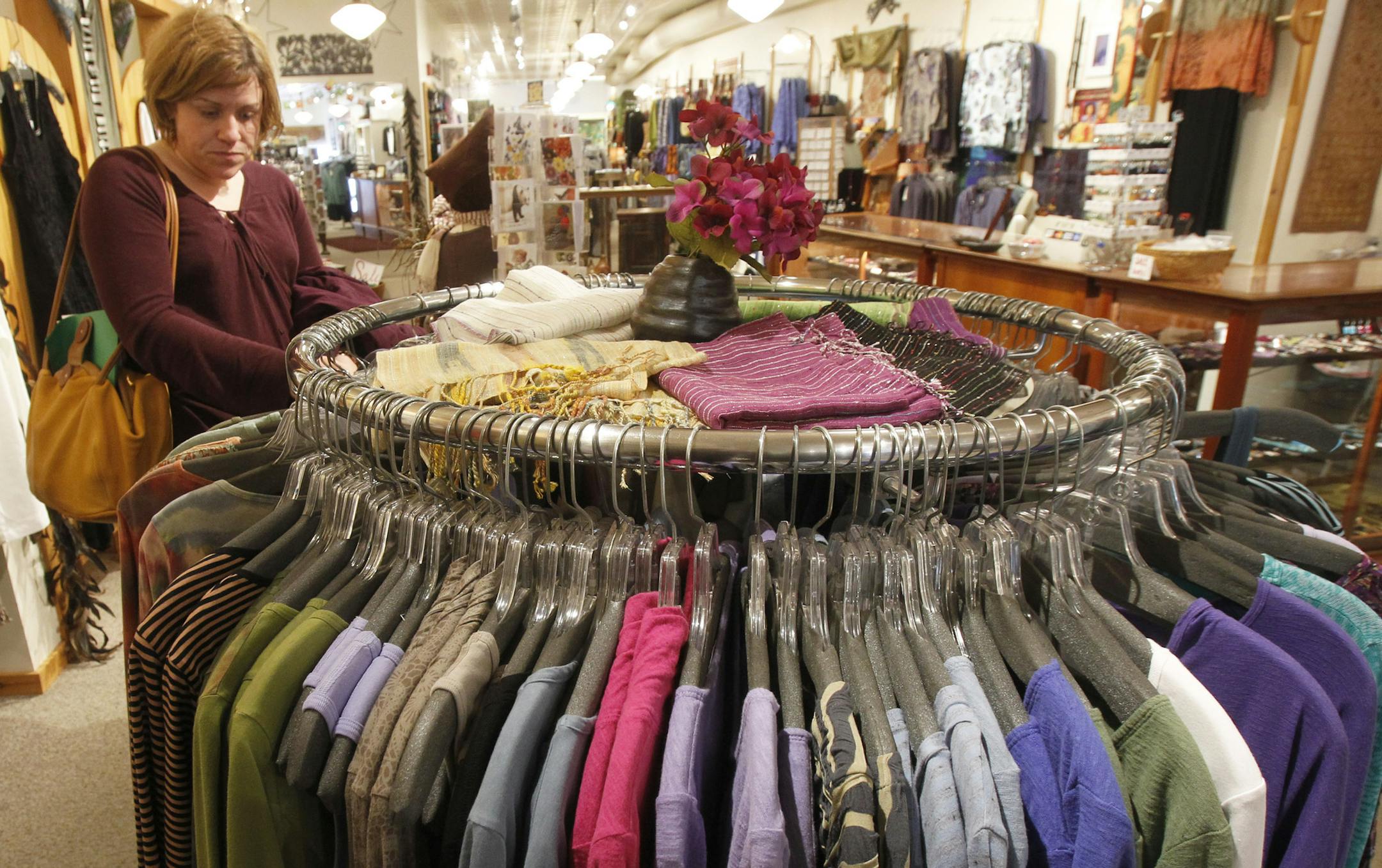 In this Tuesday, April 9, 2013 photo, a shopper looks over the clothes at the Vermont Trading Company in Montpelier, Vt. U.S. retail sales fell in March from February by the most in nine months, indicating higher taxes and weak hiring have made consumers more cautious about spending, according to the Commerce Department, on Friday, April 12, 2013. (AP Photo/Toby Talbot) ORG XMIT: MIN2013041218392095