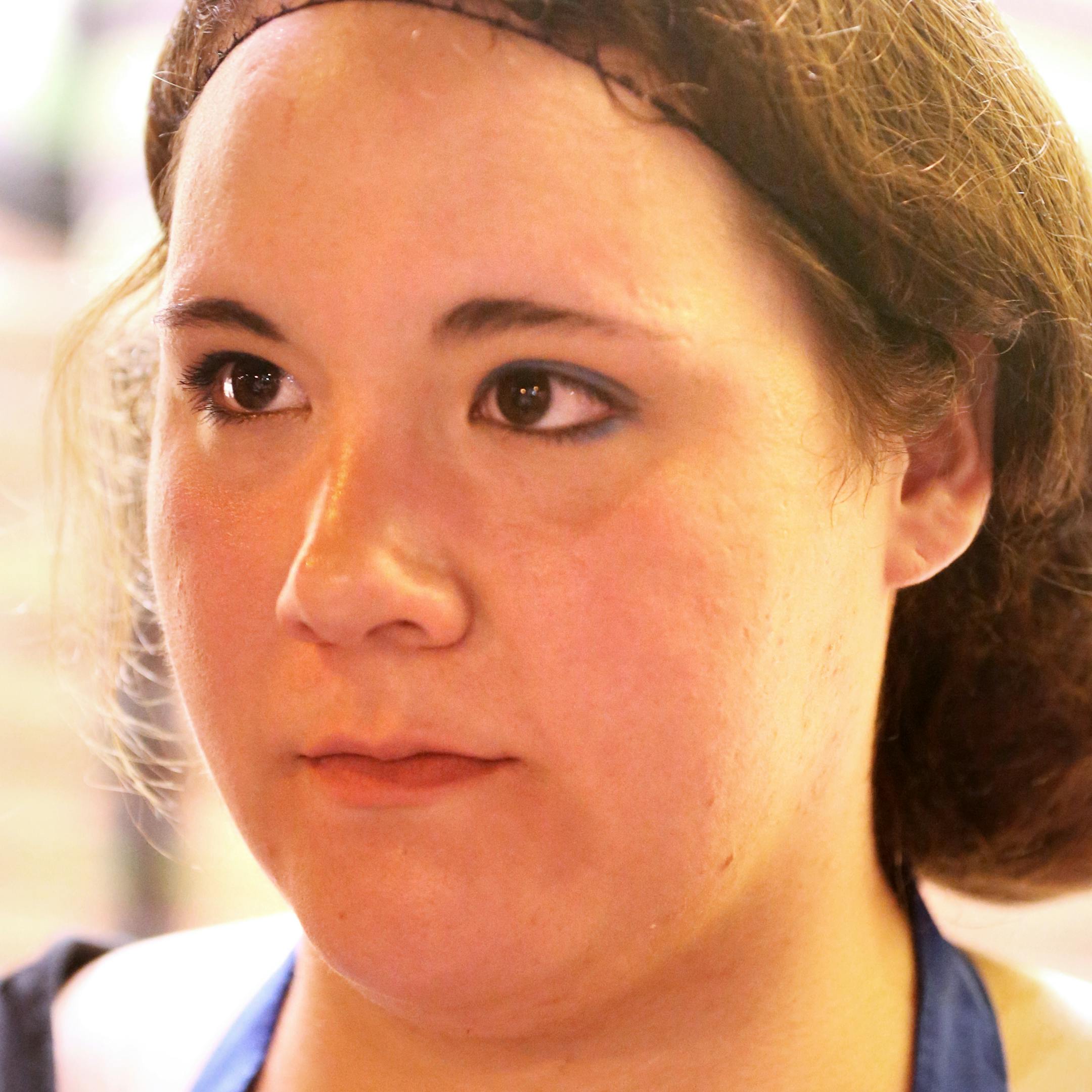 Dana Nguyen, who works at a pizza shop in downtown Minneapolis, takes a break outside on Saturday, June 20, 2015. ] LEILA NAVIDI leila.navidi@startribune.com /