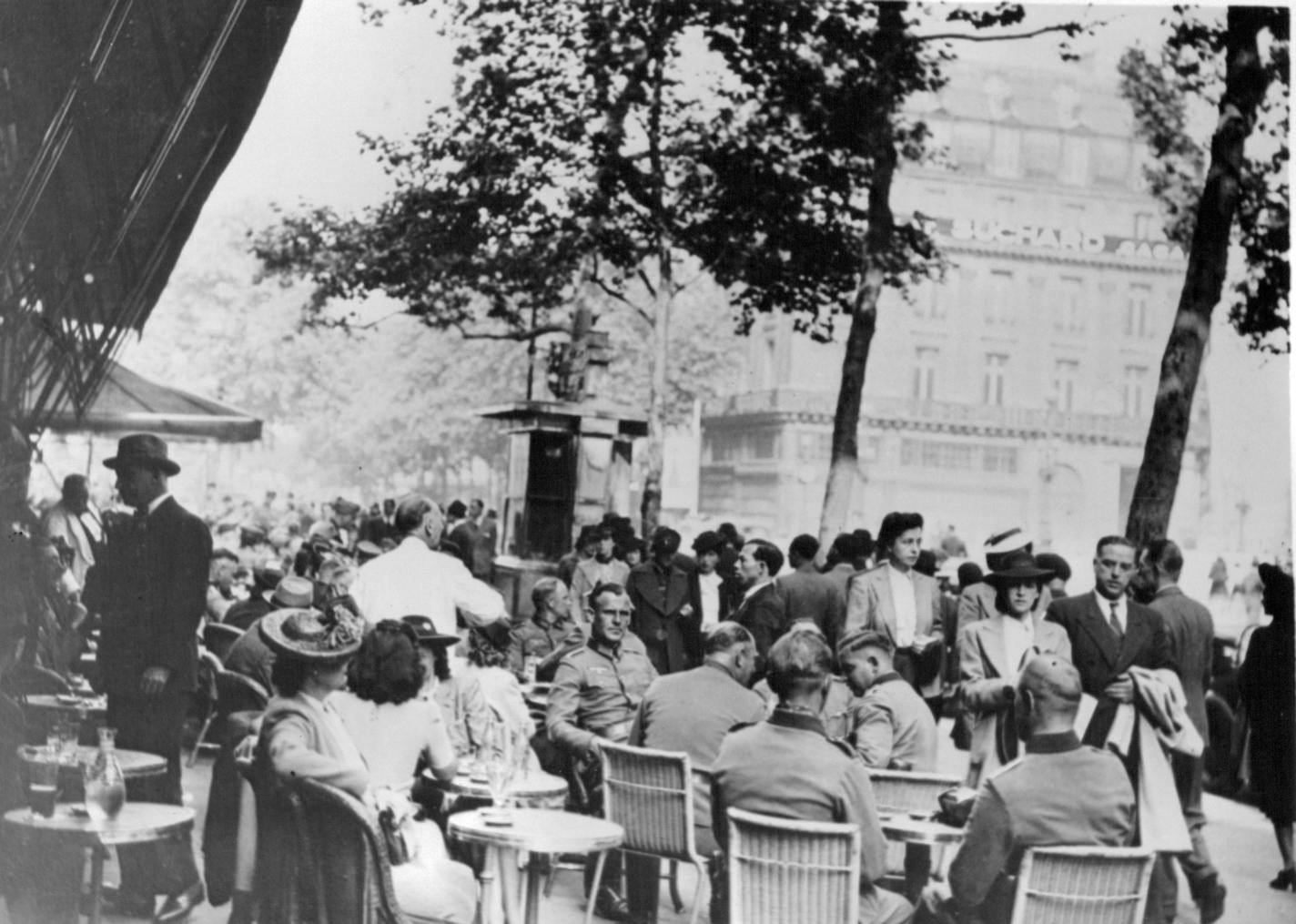 October 14, 1940 In the modern Paris, under Nazi control, German Soldiers such as these sit at the tables of the sidewalk cafes along the Guards boulevard. ACME