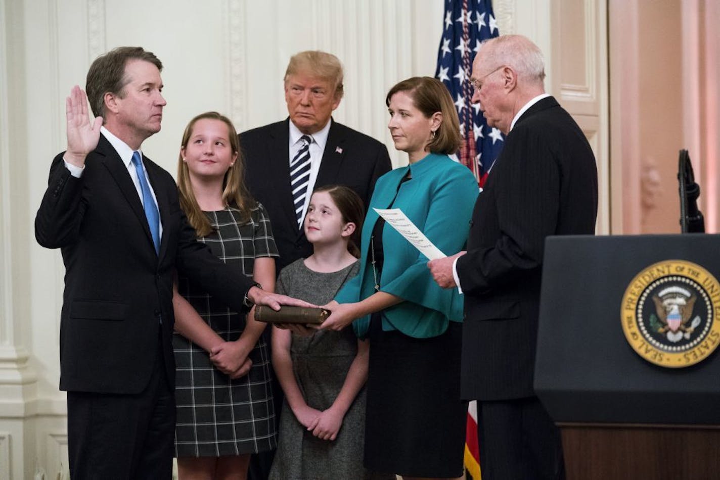 Supreme Court Justice Brett Kavanaugh is ceremonially sworn in by retiring Justice Anthony Kennedy as his family and President Donald Trump watch in the East Room of the White House in Washington, Oct. 8, 2018.