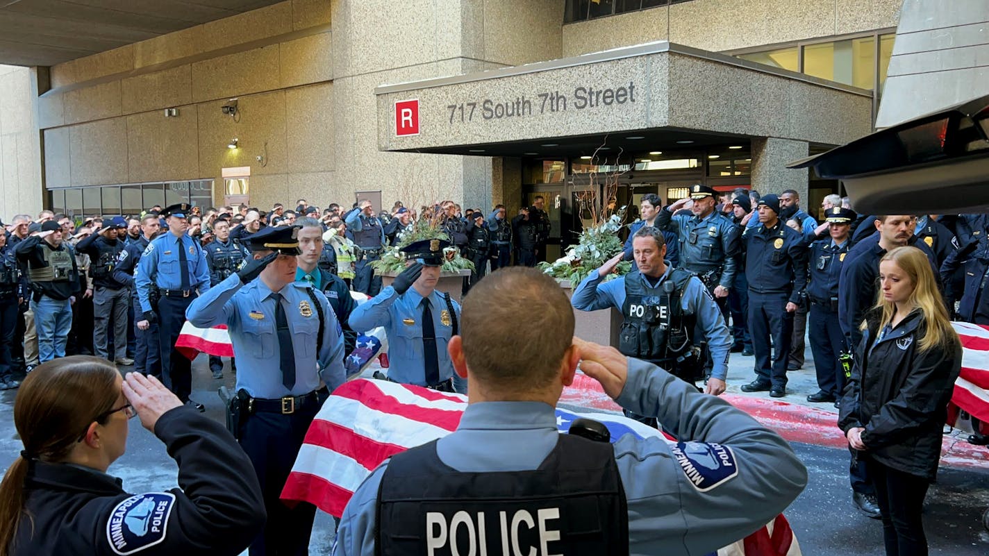 Law enforcement officials saluted as their bodies of two slain officers and a medic were transported to the Hennepin County Medical Examiner's office in Minnetonka on Sunday, Feb. 18, 2024. The two officers and medic were fatally shot while responding to an hourslong standoff in response to a domestic abuse call in Burnsville, Minn., earlier Sunday.  ] Liz Sawyer • liz.sawyer@startribune.com