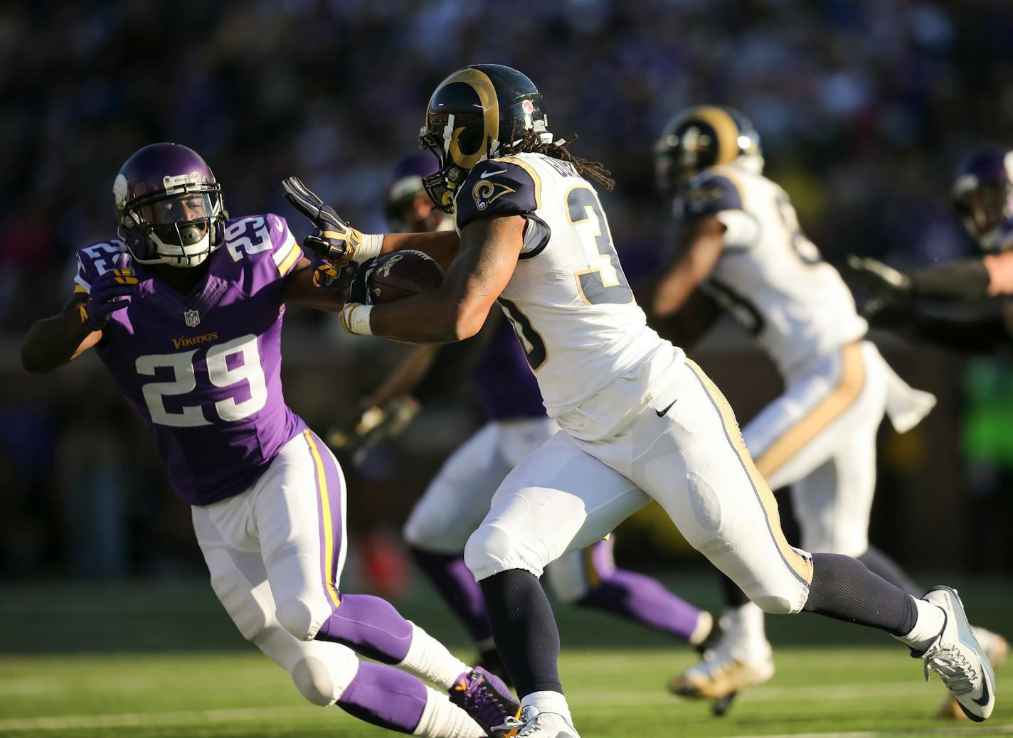 Rams running back Todd Gurley (30) prepared to stiff arm Vikings cornerback Xavier Rhodes (29) while gaining three yards in the fourth quarter Sunday afternoon.