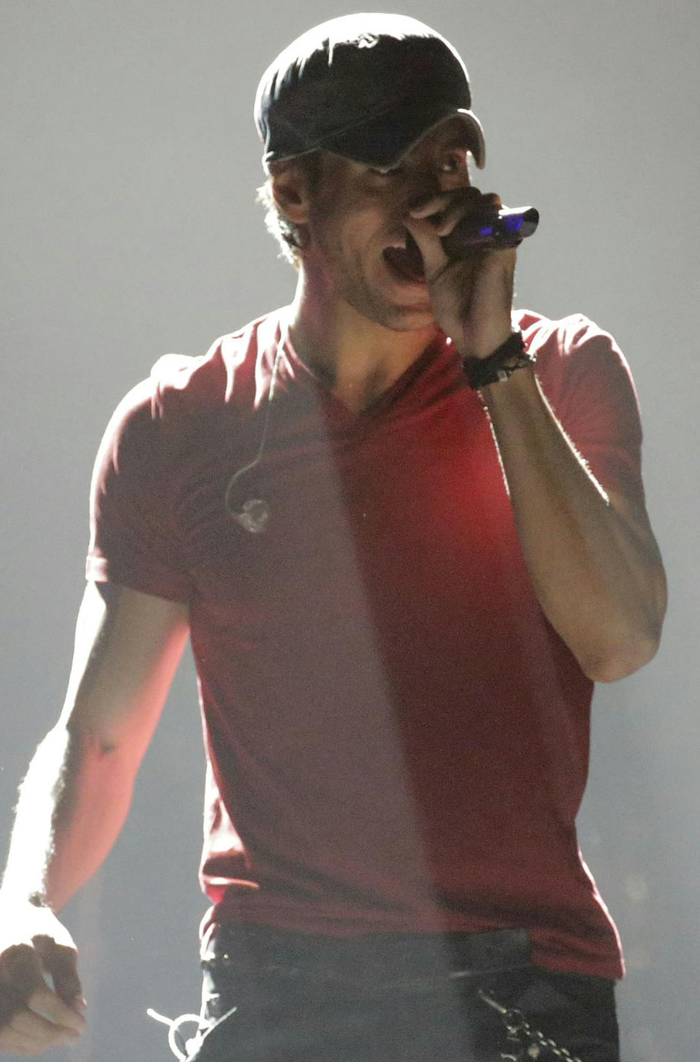 Enrique Iglesias belts out one of his hits as he performs while in concert at the Don Haskin Center in El Paso, Texas during a Sold-Out show Tuesday Jan. 27, 2015. (AP Photo/The El Paso Times, Ruben R. Ramirez)