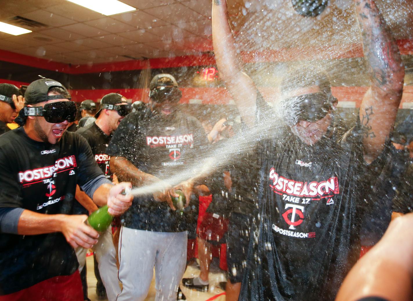 The Minnesota Twins celebrate early Thursday, Sept. 28, 2017, in Cleveland. The Twins earned an AL wild-card berth after the Los Angeles Angels lost to the Chicago White Sox. The Twins had lost 4-2 to the Cleveland Indians on Wednesday night. (AP Photo/Ron Schwane)