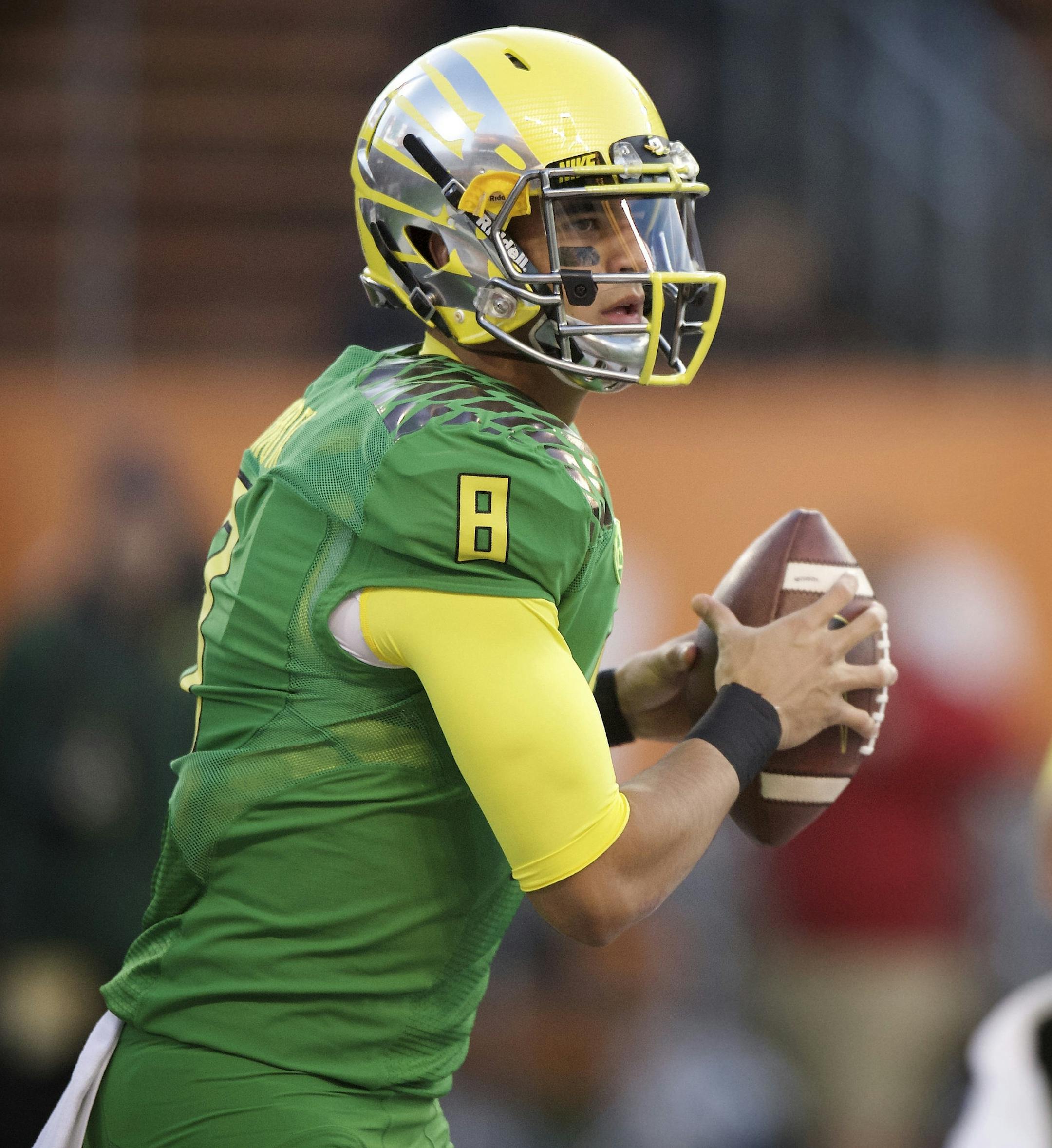 Oregon quarterback Marcus Mariota (8) warms up before an NCAA college football game against Oregon State in Corvallis, Or., Saturday, Nov. 15, 2014. (AP Photo/Troy Wayrynen)