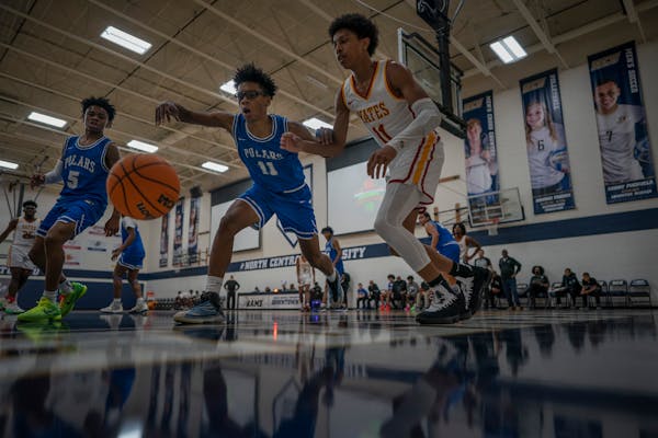 Jacob Butler left (11) of Minneapolis North reaches for the ball as Quran McKinney (11) of Jack Yates plays defense in the George Floyd Memorial Holid