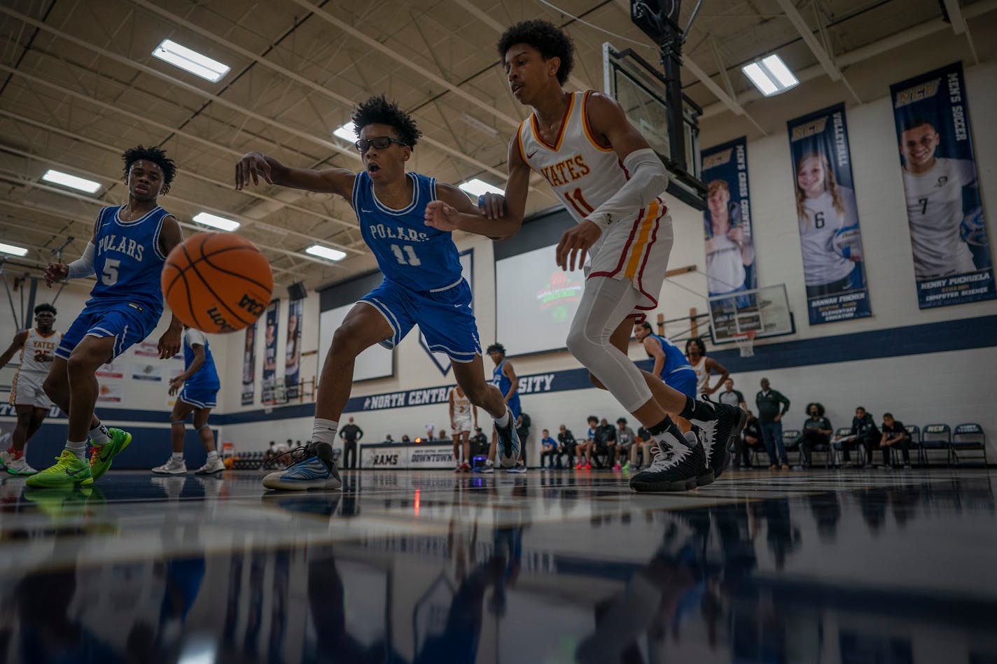 Jacob Butler left (11) of Minneapolis North reaches for the ball as Quran McKinney (11) of Jack Yates plays defense in the George Floyd Memorial Holiday Classic , in Minneapolis, Minn., on Tuesday, Dec. 28, 2021. North defeats Yates High school 95-49. Minneapolis North boys' basketball will play Houston (Texas) Yates High School in a tournament played at North Central University called the George Floyd Memorial Holiday Classic. Houston Yates was the high school Floyd played for back in the day. ] JERRY HOLT •Jerry.Holt@startribune.com