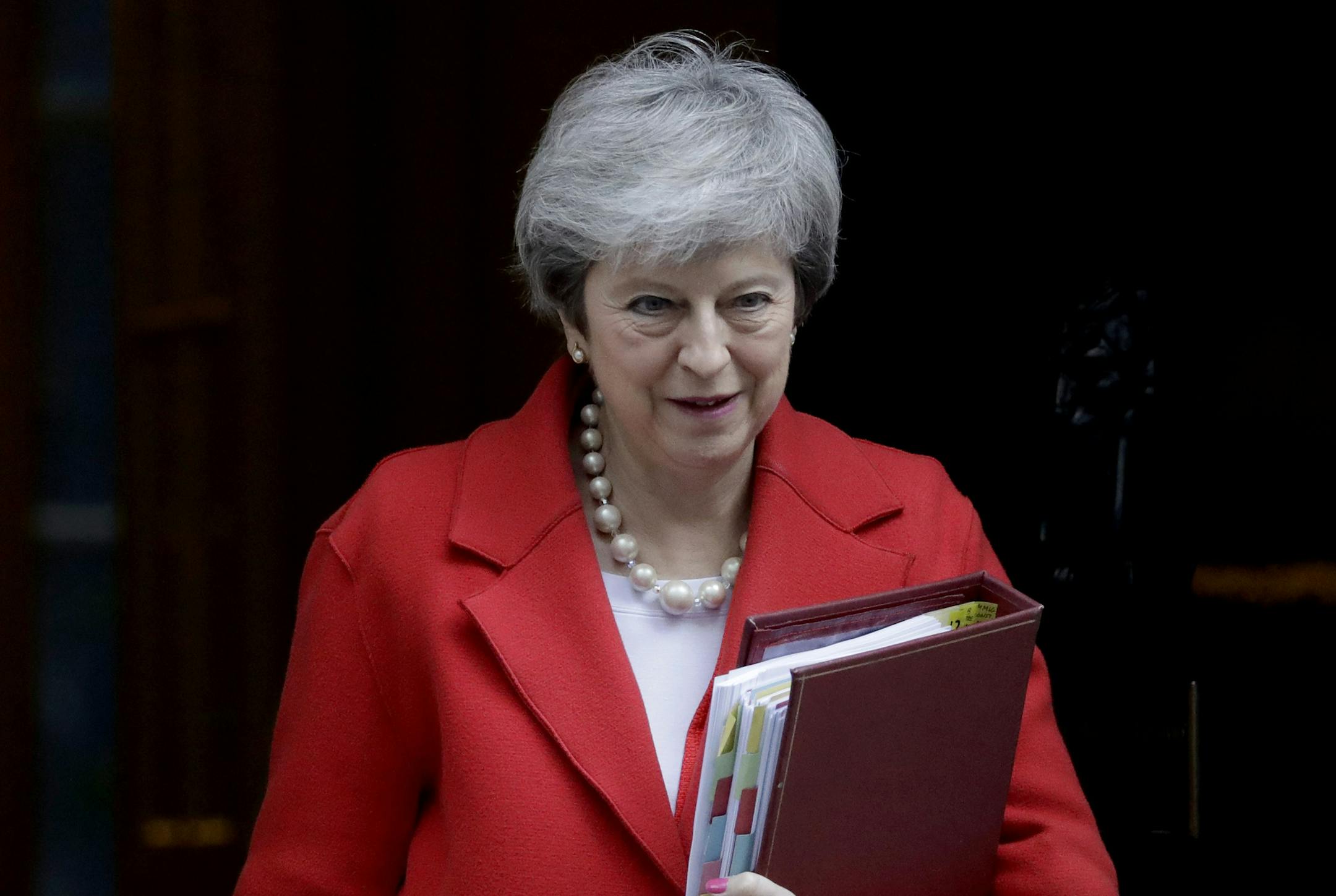 British Prime Minister Theresa May leaves 10 Downing Street in London, to attend Prime Minister's Questions at the Houses of Parliament, Wednesday, Feb. 27, 2019. May insisted Wednesday that Britain will leave the European Union on schedule next month, while the head of a major business organization said May's grudging decision to allow lawmakers to vote to delay Brexit provides an "option on sanity." (AP Photo/Matt Dunham) ORG XMIT: LMD101