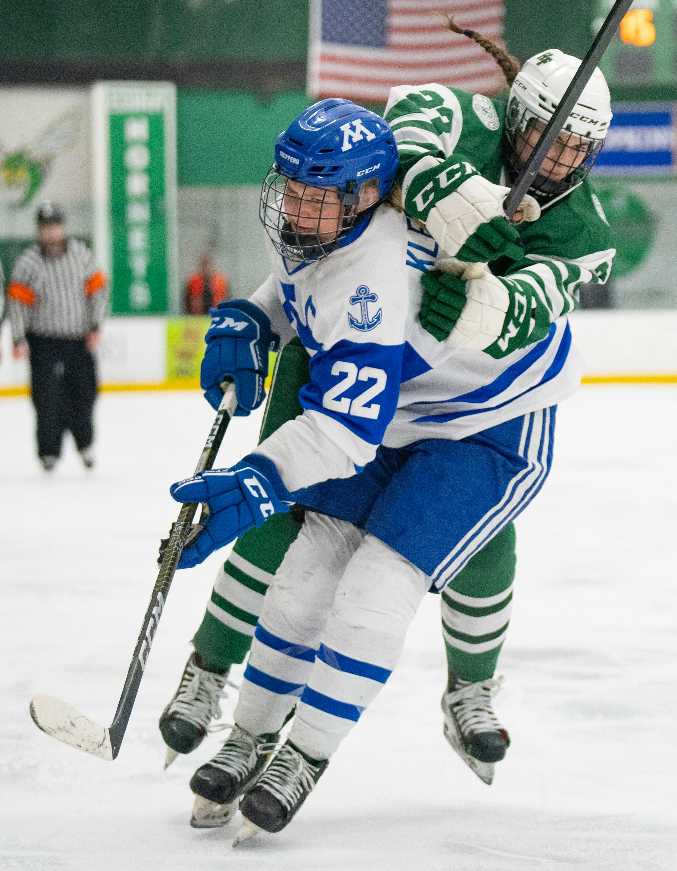 Minnetonka defender Elly Klepinger (22) prevents Holy Family defender Justina Valentini (23) from getting past her in the third period.