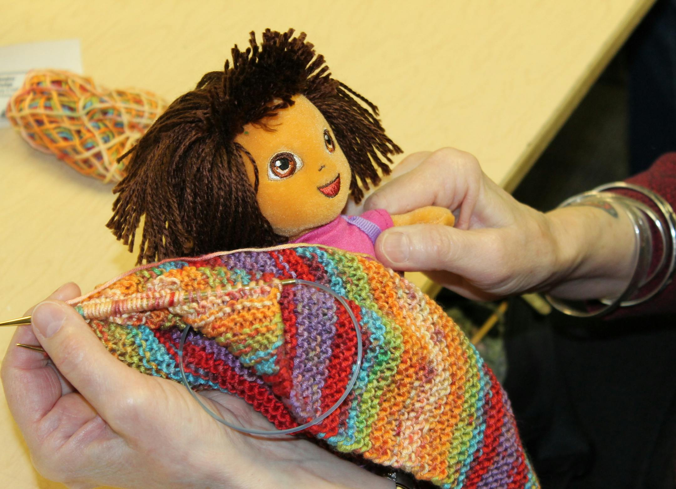 By LIALA HELAL Peggy Novisky of Lakeville knits a blanket for a Dora doll for a friend at a knitting group at Lakeville Senior Center. April 22, 2013