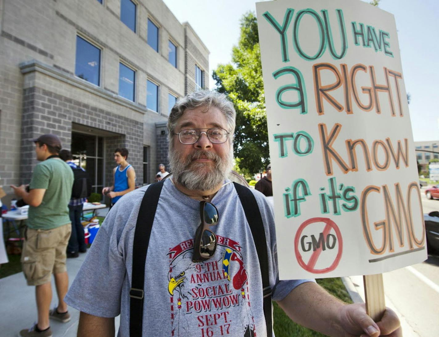 Protestor Dan Walters of Boise joins around 100 people carrying posters protesting the use of genetically modified organisms (GMO) gathered near the Boise, Idaho office of Sen. Mike Crapo Wednesday July 18, 2012. Organizers of the protest say Senators Crapo and Jim Risch voted against a proposed amendment in the Farm Bill that would have given states the right to mandate labeling of genetically modified foods. Walters said people should at least be able to see a label on a food product indicatin