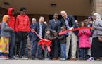Mayor Melvin Carter called on all the neighborhood kids at the grand opening to cut the big ribbon with the big scissors. On the left, Senator Foung H